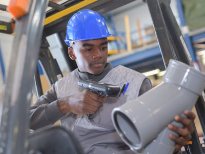 warehouseman with protective vest and scanner